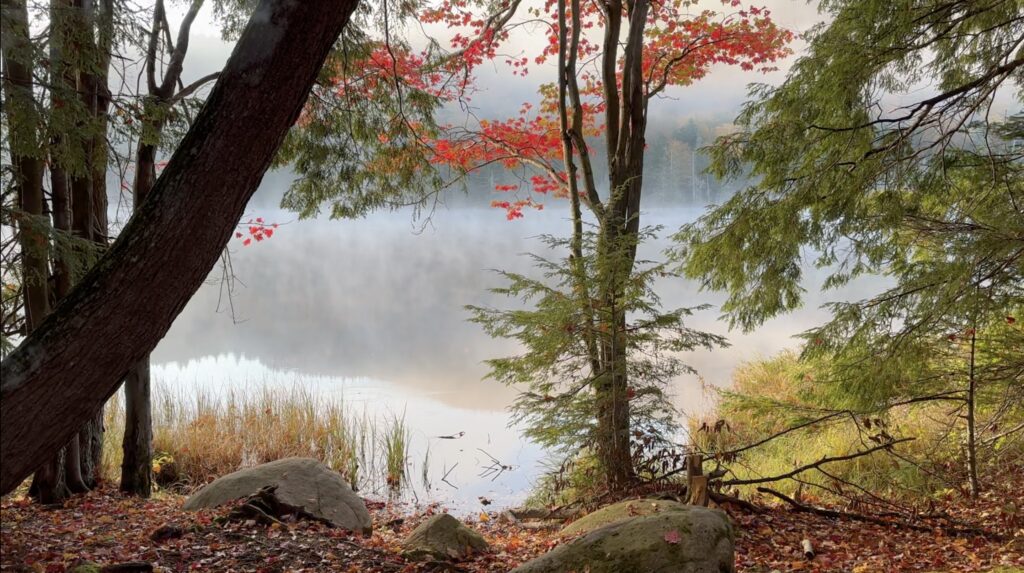 Mist rising from Puffer Pond during a Fall packrafting trip in the Adirondacks